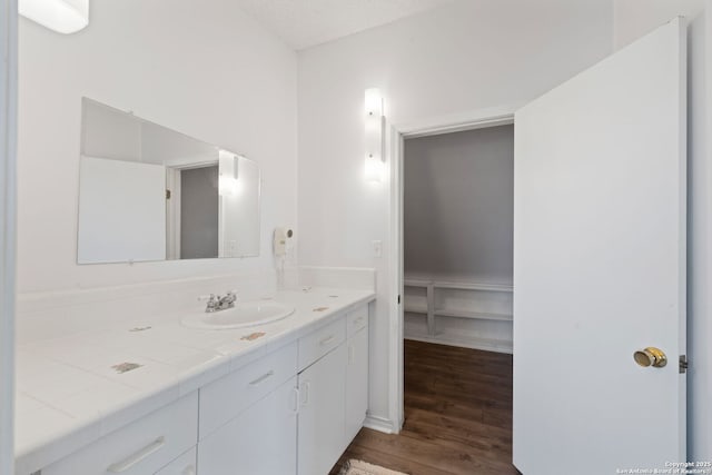 388 Oak, Pipe Creek, TX 78063 - bathroom featuring wood finished floors and vanity