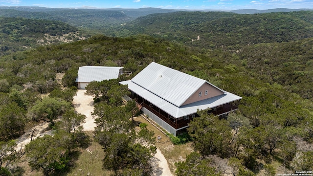 388 Oak, Pipe Creek, TX 78063 - view from above of property featuring a heavily wooded area and a mountainous background
