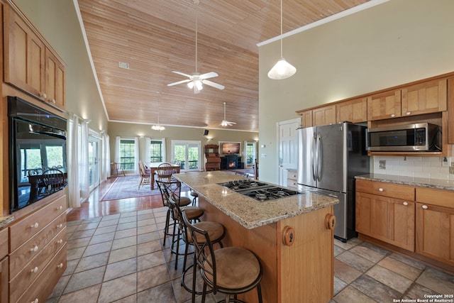 388 Oak, Pipe Creek, TX 78063 - kitchen with stainless steel appliances, high vaulted ceiling, wood ceiling, ornamental molding, and a breakfast bar
