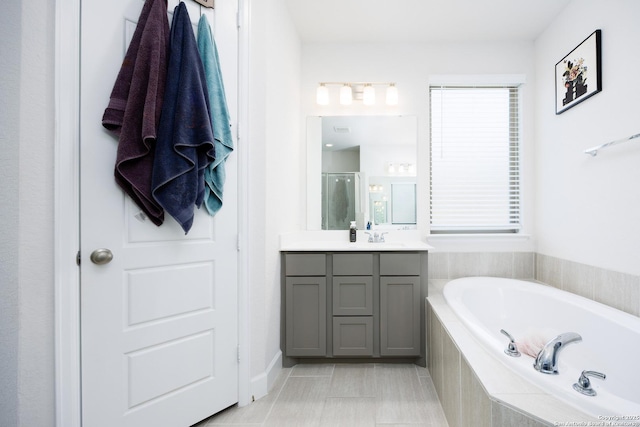807 Swenson Rnch, San Antonio, TX 78245 - bathroom featuring vanity, a garden tub, a shower, and tile patterned flooring