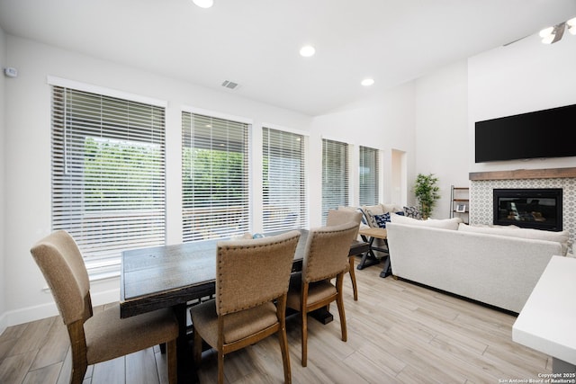 807 Swenson Rnch, San Antonio, TX 78245 - dining space featuring light wood-type flooring, a fireplace, and recessed lighting
