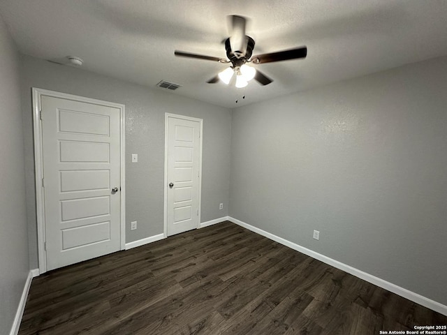 1116 Eagle, Seguin, TX 78155 - unfurnished bedroom featuring dark wood-type flooring, baseboards, and a ceiling fan