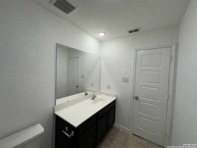 1116 Eagle, Seguin, TX 78155 - bathroom featuring tile patterned flooring, toilet, and vanity