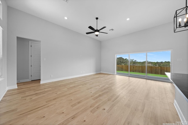 207 Azalea Aly, Castroville, TX 78009 - empty room with a ceiling fan, light wood-style flooring, a chandelier, recessed lighting, and baseboards