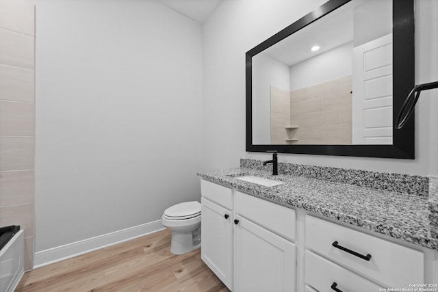207 Azalea Aly, Castroville, TX 78009 - full bathroom featuring wood finished floors, vanity, toilet, a shower, and baseboards
