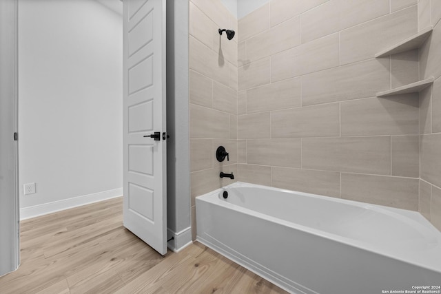 207 Azalea Aly, Castroville, TX 78009 - full bathroom featuring wood finished floors, shower / bathtub combination, and baseboards