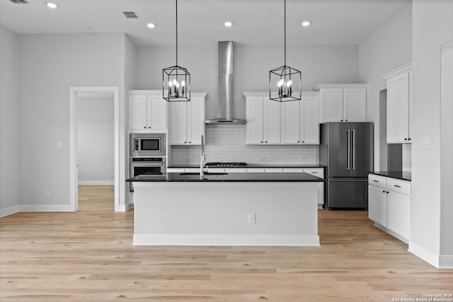 207 Azalea Aly, Castroville, TX 78009 - kitchen featuring stainless steel appliances, wall chimney range hood, dark countertops, white cabinets, and recessed lighting