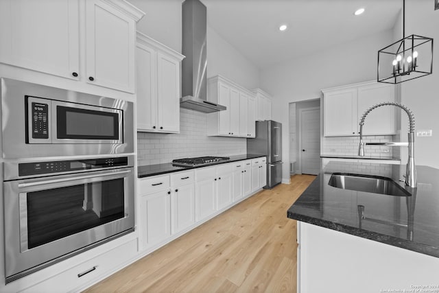 207 Azalea Aly, Castroville, TX 78009 - kitchen featuring stainless steel appliances, a sink, wall chimney exhaust hood, white cabinetry, and recessed lighting