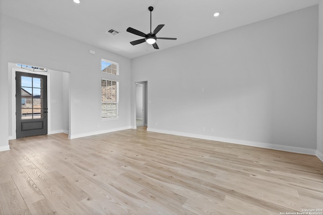 207 Azalea Aly, Castroville, TX 78009 - spare room with ceiling fan, light wood finished floors, baseboards, recessed lighting, and a high ceiling