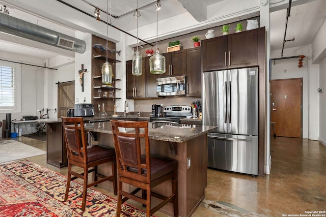 831 S Flores Unit 2201, San Antonio, TX 78204 - kitchen featuring stainless steel appliances, dark brown cabinetry, open shelves, a breakfast bar area, and finished concrete floors