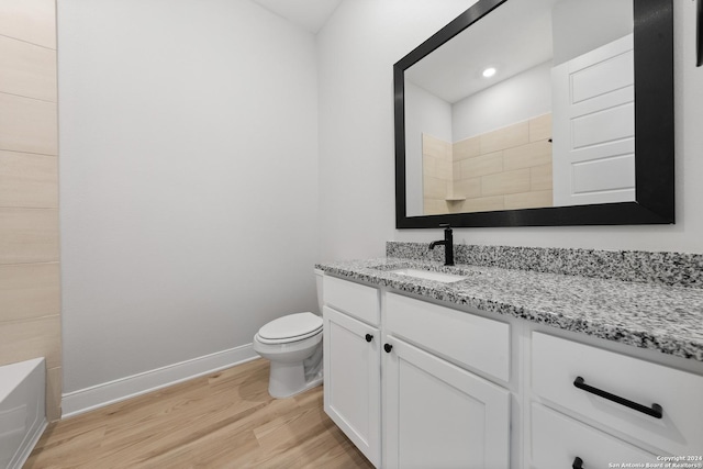 191 Azalea Aly, Castroville, TX 78009 - bathroom featuring wood finished floors, baseboards, vanity, toilet, and a shower