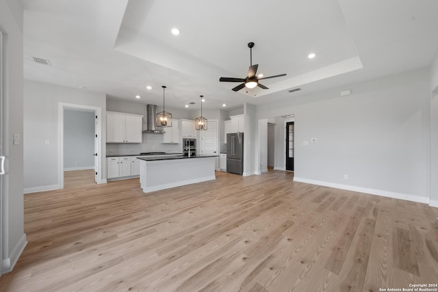 191 Azalea Aly, Castroville, TX 78009 - kitchen with wall chimney range hood, open floor plan, high quality fridge, dark countertops, and recessed lighting