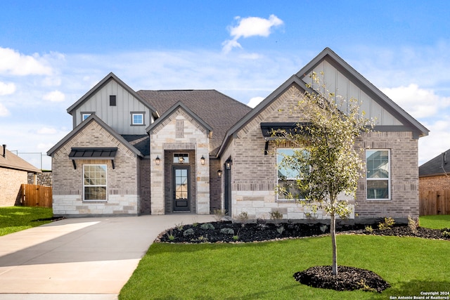 243 Wisteria Vw, Castroville, TX 78009 - view of front of house featuring board and batten siding, concrete driveway, and roof with shingles