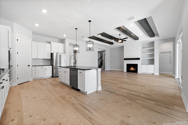 243 Wisteria Vw, Castroville, TX 78009 - kitchen featuring a sink, dark countertops, freestanding refrigerator, black dishwasher, and a fireplace