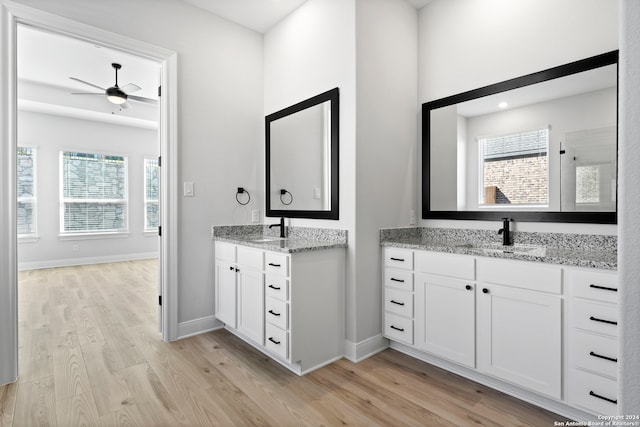 243 Wisteria Vw, Castroville, TX 78009 - bathroom featuring wood finished floors, ceiling fan, and plenty of natural light