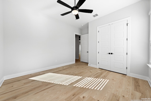 243 Wisteria Vw, Castroville, TX 78009 - unfurnished bedroom featuring wood finished floors, baseboards, a closet, and ceiling fan