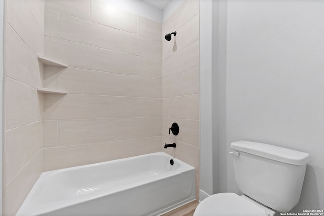 243 Wisteria Vw, Castroville, TX 78009 - bathroom with toilet, shower / bathtub combination, and wood finished floors