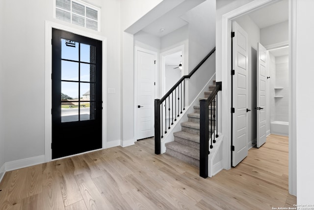 243 Wisteria Vw, Castroville, TX 78009 - entryway featuring light wood-style flooring, stairway, baseboards, and ceiling fan