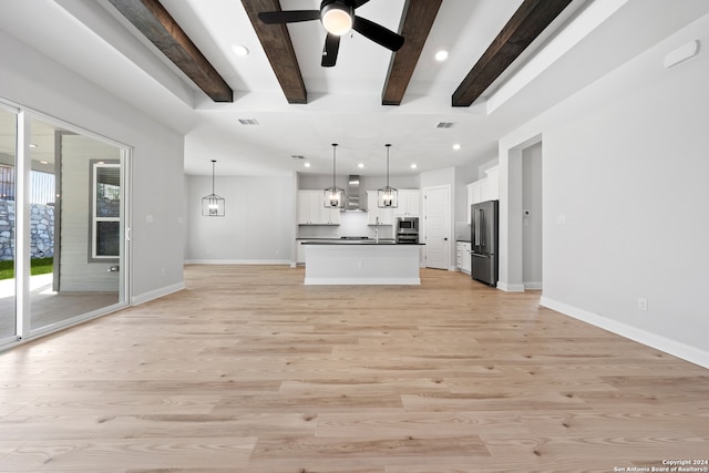 243 Wisteria Vw, Castroville, TX 78009 - unfurnished living room with beamed ceiling, light wood finished floors, baseboards, a ceiling fan, and recessed lighting