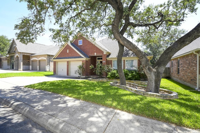 27218 Spiral Cyn, San Antonio, TX 78261 - view of front of house featuring a garage, driveway, a front lawn, brick siding, and roof with shingles