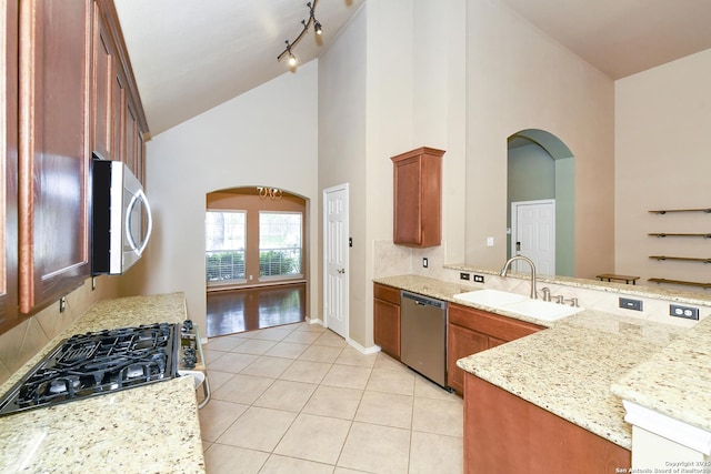 27218 Spiral Cyn, San Antonio, TX 78261 - kitchen with appliances with stainless steel finishes, a sink, high vaulted ceiling, arched walkways, and tasteful backsplash