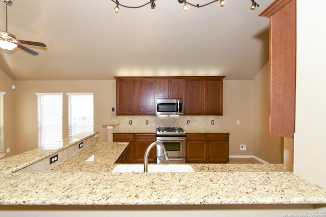 27218 Spiral Cyn, San Antonio, TX 78261 - kitchen with appliances with stainless steel finishes, a sink, backsplash, vaulted ceiling, and a ceiling fan