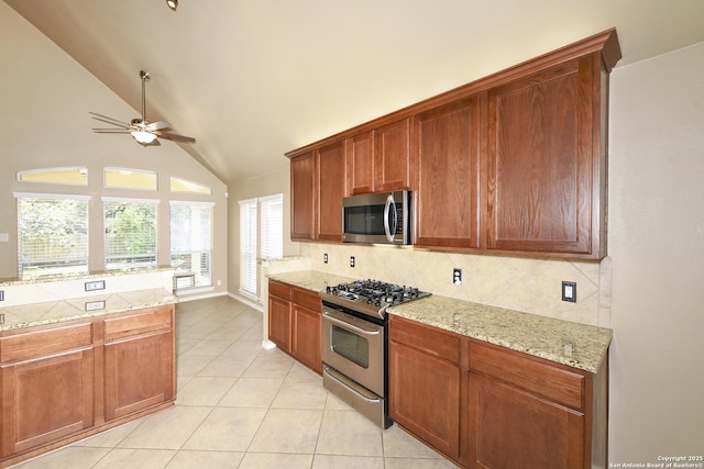 27218 Spiral Cyn, San Antonio, TX 78261 - kitchen featuring appliances with stainless steel finishes, backsplash, a ceiling fan, light tile patterned floors, and high vaulted ceiling