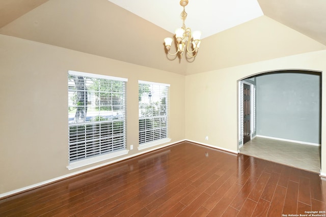 27218 Spiral Cyn, San Antonio, TX 78261 - empty room with a chandelier, lofted ceiling, wood finished floors, baseboards, and arched walkways