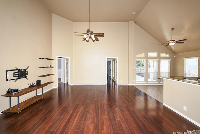 27218 Spiral Cyn, San Antonio, TX 78261 - unfurnished living room featuring ceiling fan, high vaulted ceiling, wood finished floors, plenty of natural light, and baseboards