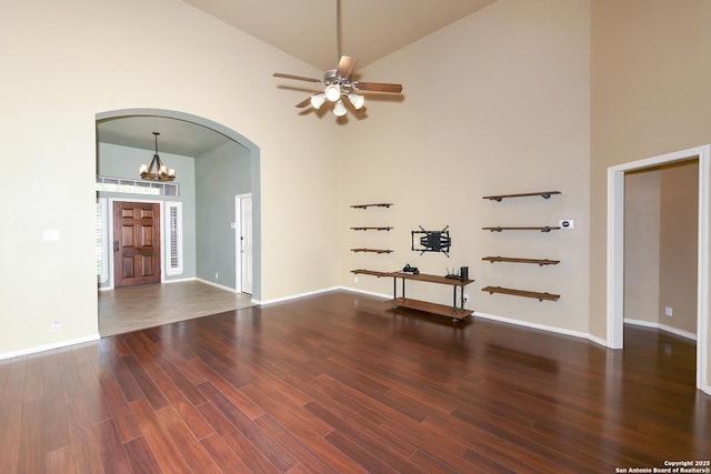 27218 Spiral Cyn, San Antonio, TX 78261 - empty room with high vaulted ceiling, arched walkways, wood finished floors, ceiling fan, and a chandelier