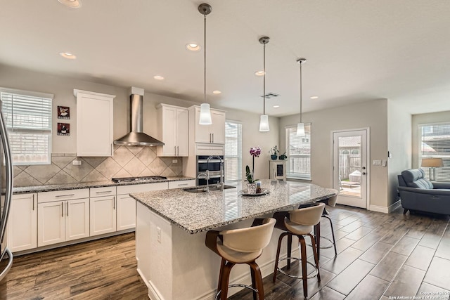 2215 Zachry, New Braunfels, TX 78132 - kitchen with wall chimney exhaust hood, stainless steel appliances, a sink, healthy amount of natural light, and recessed lighting