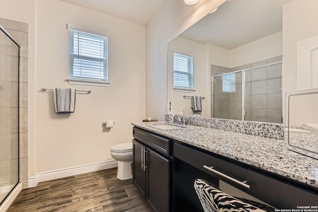 2215 Zachry, New Braunfels, TX 78132 - full bath featuring a shower stall, baseboards, wood finished floors, vanity, and toilet