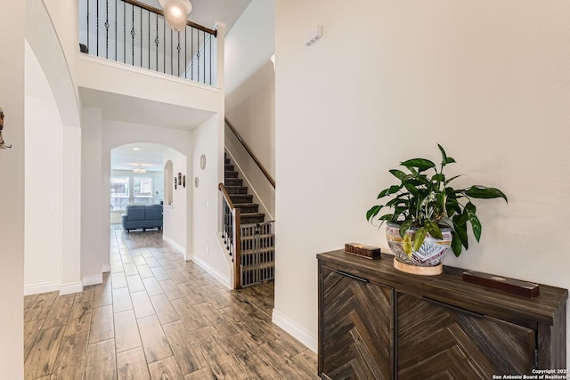 2215 Zachry, New Braunfels, TX 78132 - foyer with arched walkways, stairs, wood finished floors, baseboards, and a towering ceiling