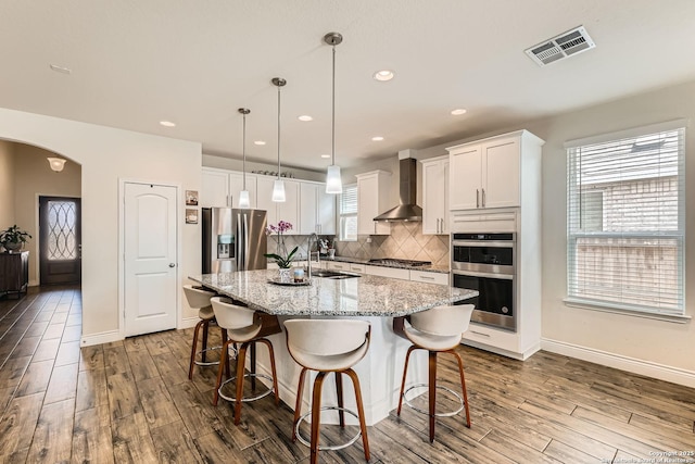 2215 Zachry, New Braunfels, TX 78132 - kitchen with appliances with stainless steel finishes, wall chimney range hood, dark wood-style floors, white cabinetry, and recessed lighting