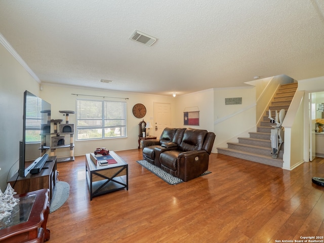 7815 Bypass Shls, San Antonio, TX 78244 - living area with stairway, wood finished floors, a textured ceiling, and crown molding