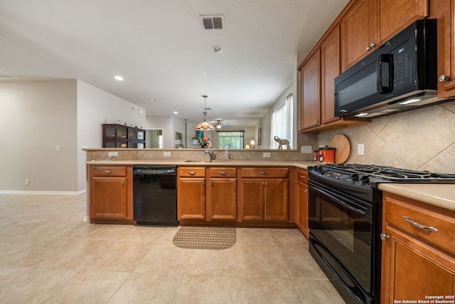 12518 Cascade Hls, San Antonio, TX 78253 - kitchen with black appliances, a sink, a peninsula, brown cabinets, and recessed lighting
