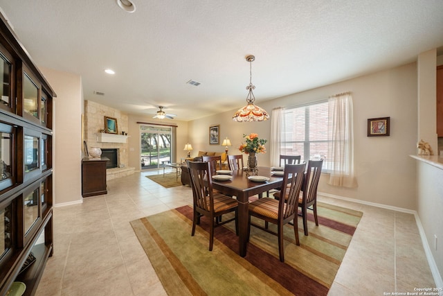 12518 Cascade Hls, San Antonio, TX 78253 - dining space featuring light tile patterned floors, a fireplace, baseboards, a ceiling fan, and recessed lighting
