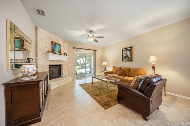 12518 Cascade Hls, San Antonio, TX 78253 - living area featuring a stone fireplace, ceiling fan, light tile patterned floors, and baseboards