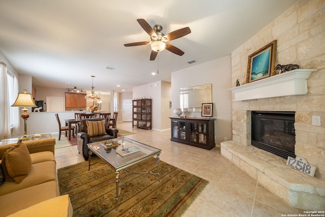 12518 Cascade Hls, San Antonio, TX 78253 - living area featuring light tile patterned floors, plenty of natural light, a ceiling fan, and a fireplace