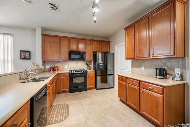 12518 Cascade Hls, San Antonio, TX 78253 - kitchen featuring black appliances, a sink, backsplash, and brown cabinets