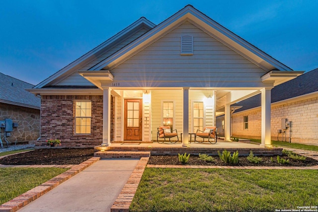 1459 Janets, New Braunfels, TX 78130 - view of front of property featuring covered porch, a front lawn, and brick siding
