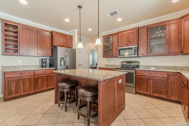 1459 Janets, New Braunfels, TX 78130 - kitchen featuring appliances with stainless steel finishes, light tile patterned floors, ornamental molding, a center island, and pendant lighting