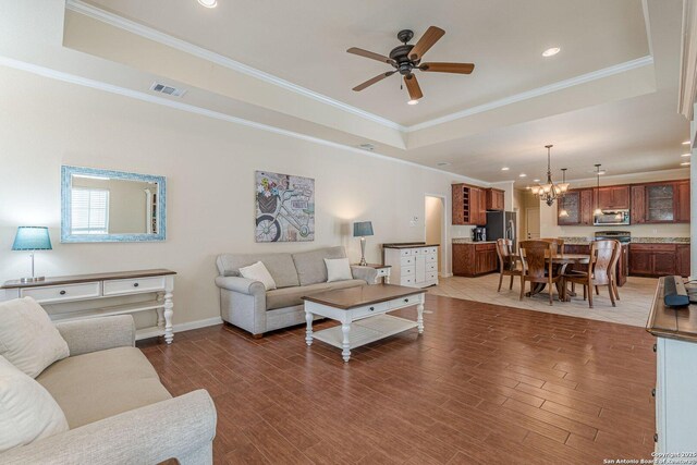 1459 Janets, New Braunfels, TX 78130 - living area with a tray ceiling, a chandelier, a ceiling fan, wood finished floors, and ornamental molding