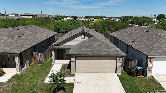 3526 Angus, San Antonio, TX 78245 - ranch-style house featuring a garage, concrete driveway, roof with shingles, brick siding, and a residential view