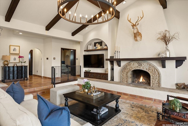 8122 Triple Crown, Fair Oaks Ranch, TX 78015 - living room with arched walkways, beam ceiling, a lit fireplace, recessed lighting, and tile patterned floors
