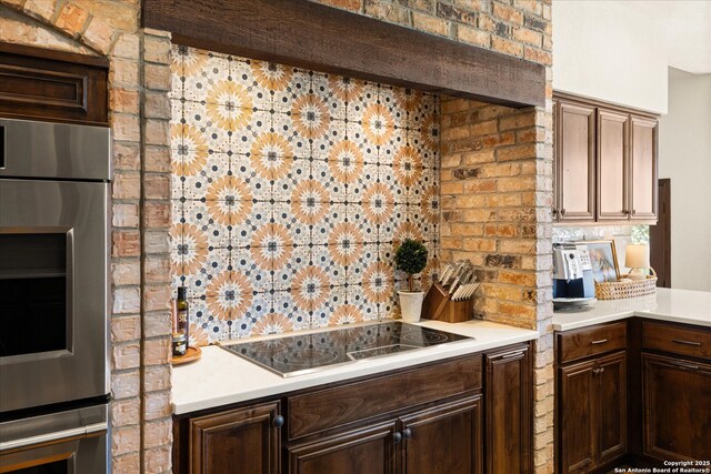 8122 Triple Crown, Fair Oaks Ranch, TX 78015 - kitchen featuring black electric cooktop, backsplash, stainless steel double oven, and light countertops