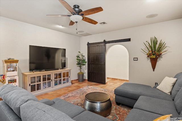8122 Triple Crown, Fair Oaks Ranch, TX 78015 - tiled living area featuring a barn door, a ceiling fan, and baseboards