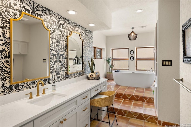 8122 Triple Crown, Fair Oaks Ranch, TX 78015 - bathroom featuring wallpapered walls, a freestanding bath, vanity, a textured ceiling, and recessed lighting