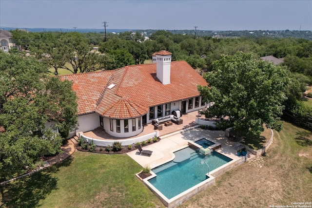 8122 Triple Crown, Fair Oaks Ranch, TX 78015 - rear view of property featuring a tile roof, a chimney, stucco siding, a lawn, and a patio area