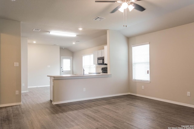 2340 Arctic Warbler, New Braunfels, TX 78130 - unfurnished living room with vaulted ceiling, wood finished floors, ceiling fan, baseboards, and a sink